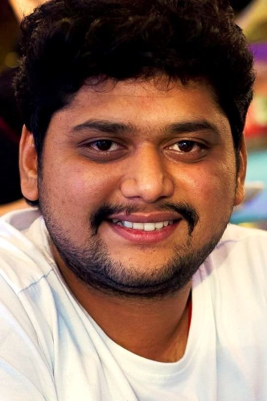 B. Ajaneesh Loknath backdrop