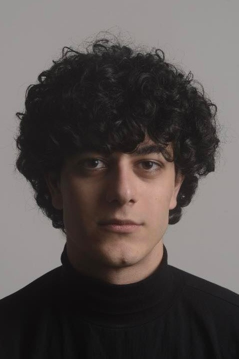 John Korres backdrop