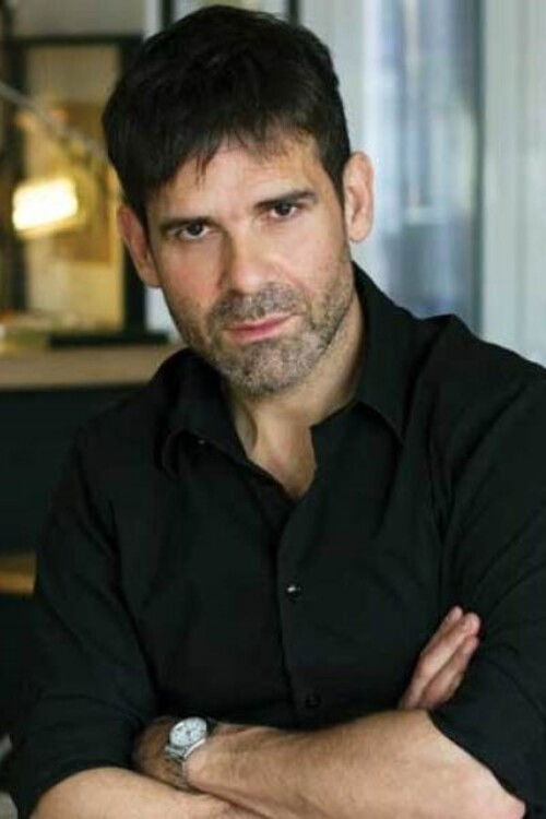 Menelaos Karamaghiolis backdrop